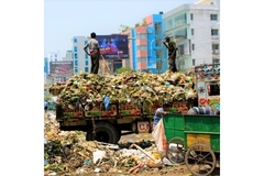 People standing on waste in the streets.